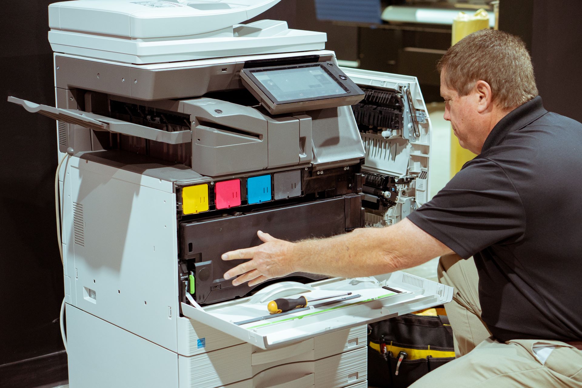 Bayne's service technician repairing a copier